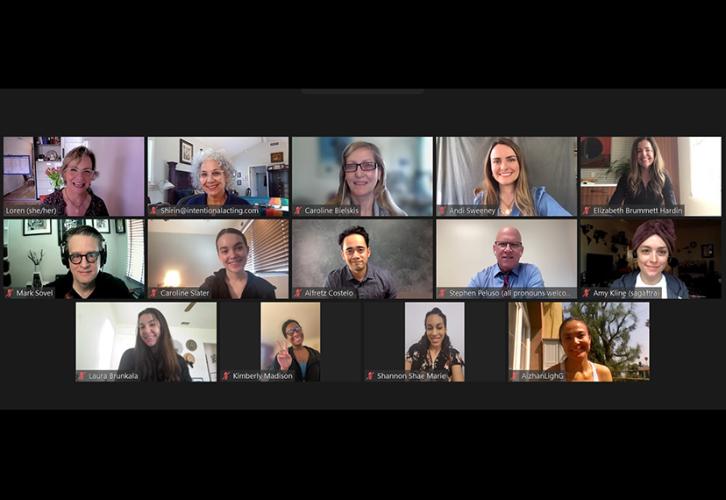 A Zoom screen with fourteen boxes of people smiling. 