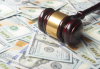 Court gavel on scattered dollar bills